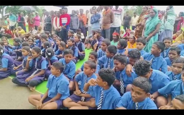 बारिश में भीगते बच्चों और पालकों ने स्कूल के बाहर किया प्रदर्शन